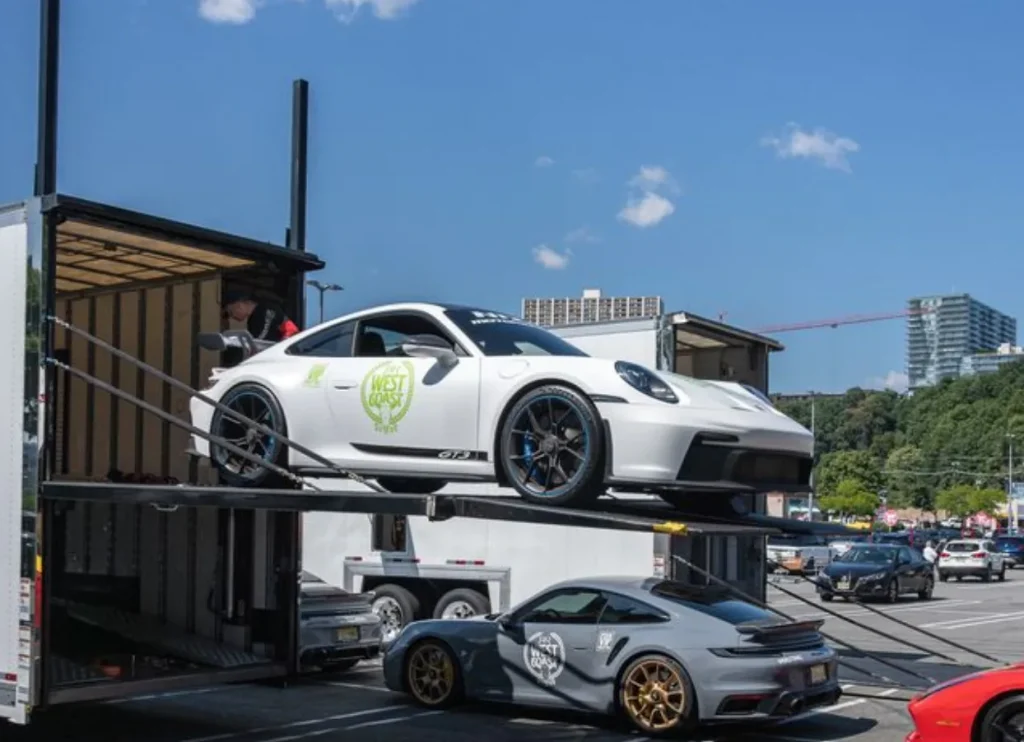 Sports cars on two levels of a car carrier.