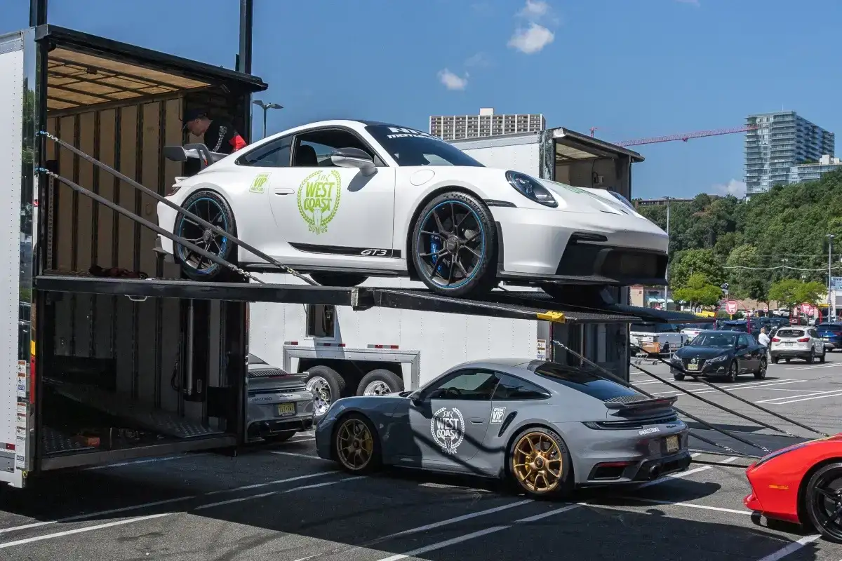 Sports cars on two levels of a car carrier.